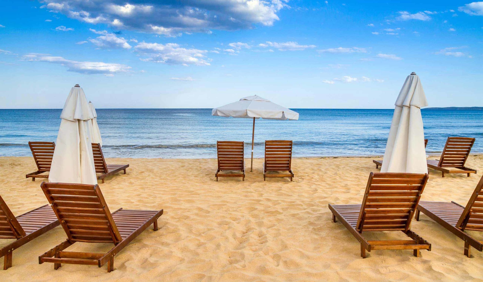 beach-umbrellas-and-deck-chairs-on-the-sandy-sea-shore-dartmouth-ma